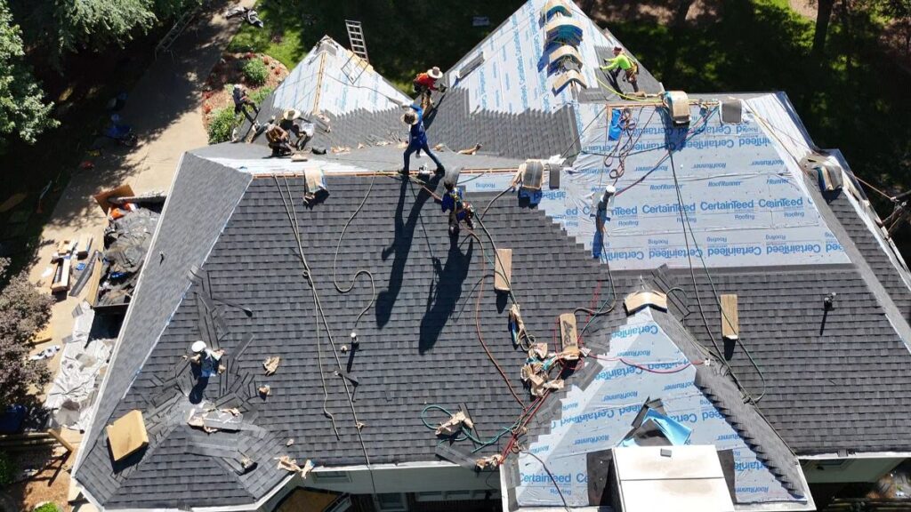 Drone view of roofing team replacing a roof