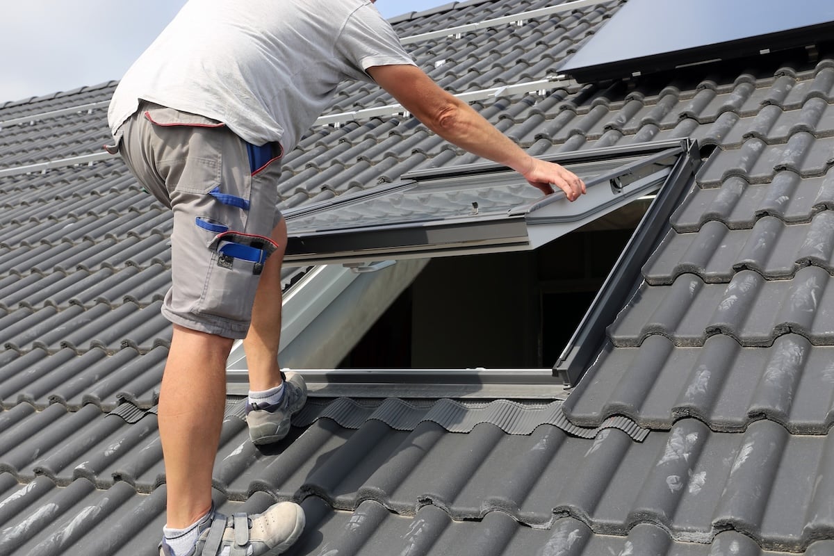 Roofer installing a skylight