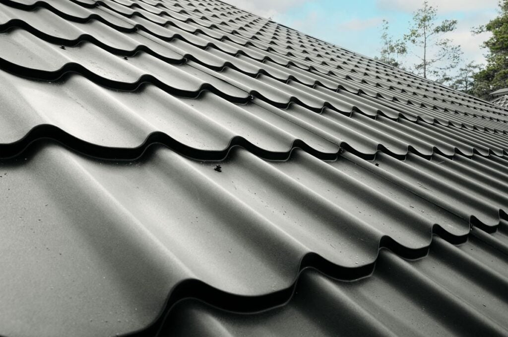 cost of metal roof vs shingle closeup metallic black roof sunny weather