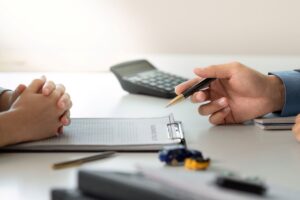 roof insurance claim worker and client calculating