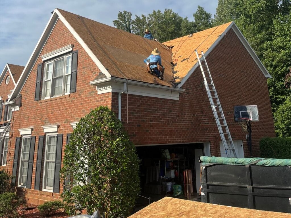 roof decking Rock Roofing project worker replacing shingles roof