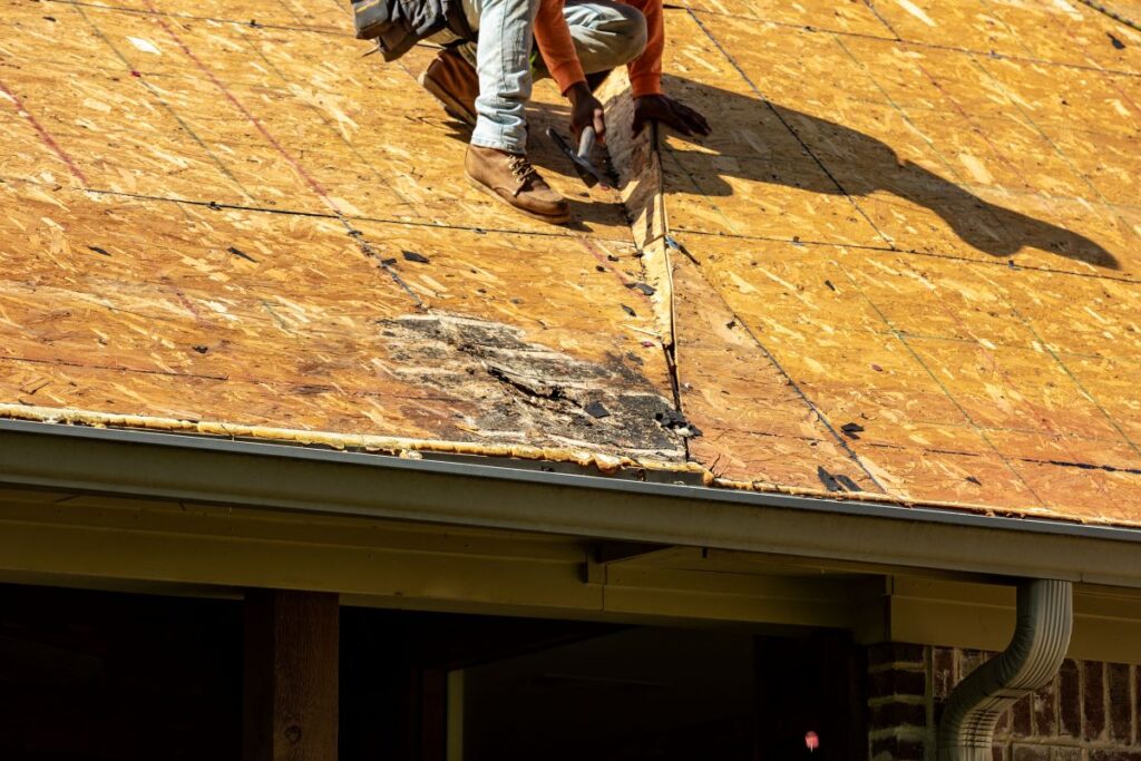 roof decking worker repairing roof