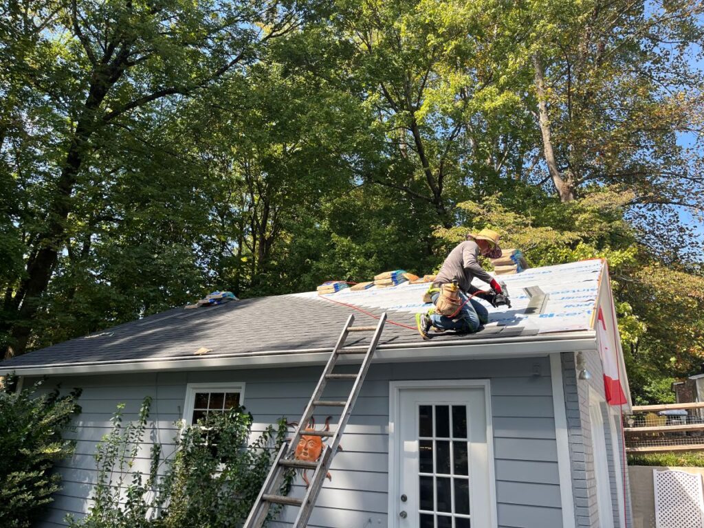 should i tell insurance about new roof Rock Roofing worker removing shingles