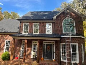 roof inspection for insurance big house Rock Roofing ladder against brick house