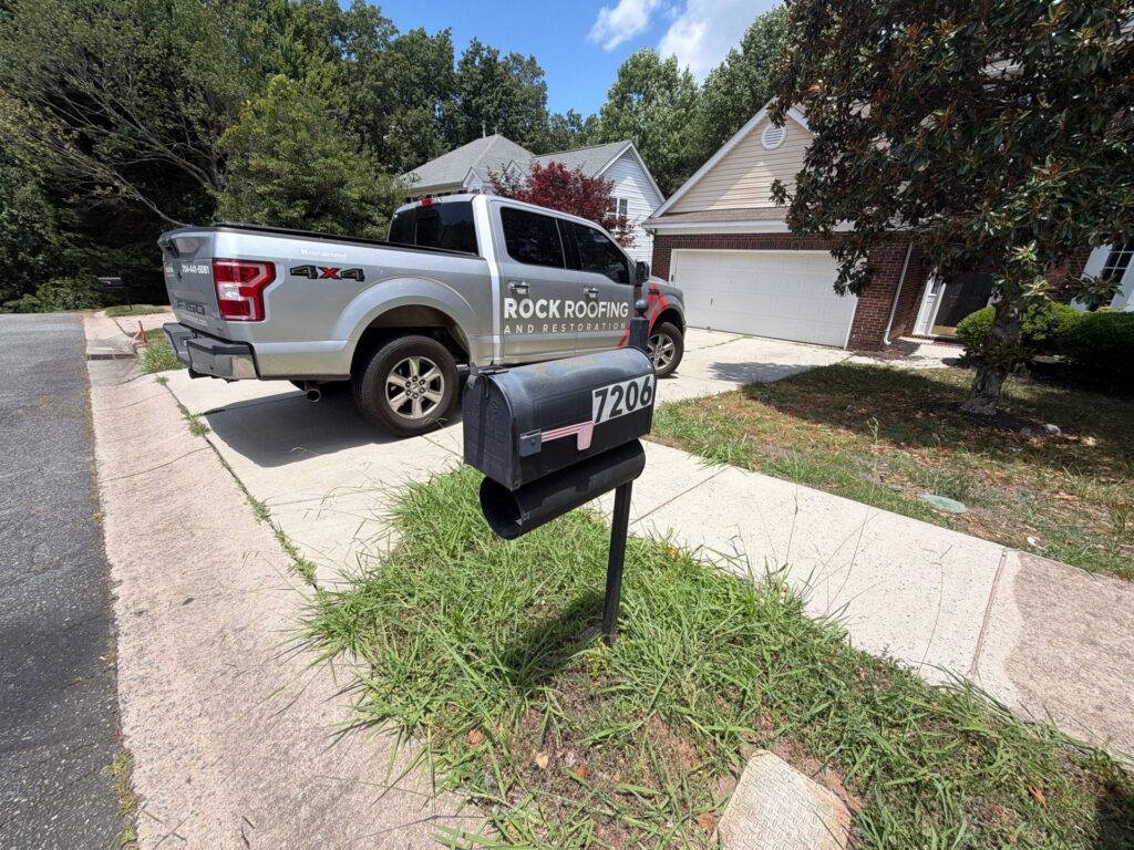emergency roof repair truck parked outside house