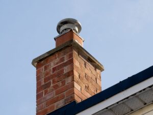 chimney cap orange brick wall