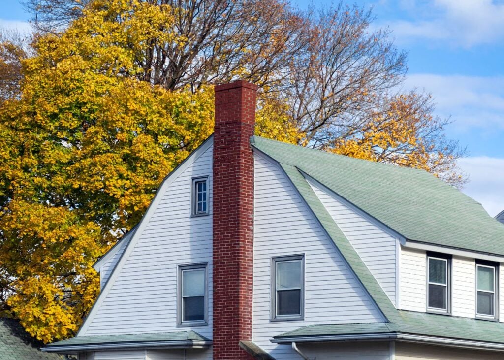 green gambrel roof with long chimney