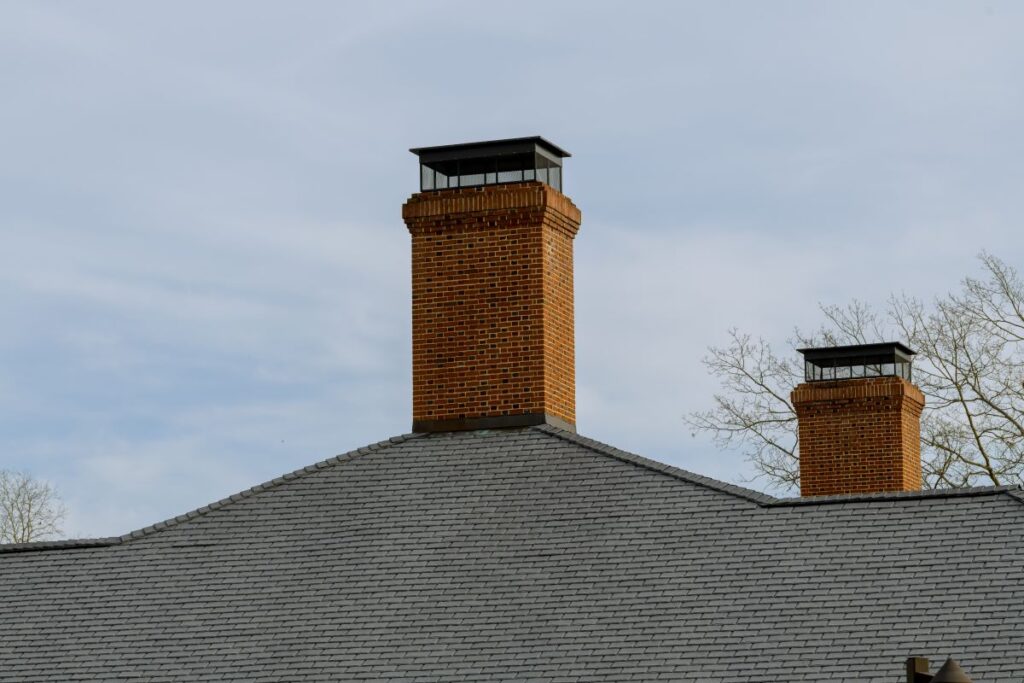two chimney caps big shingles roof